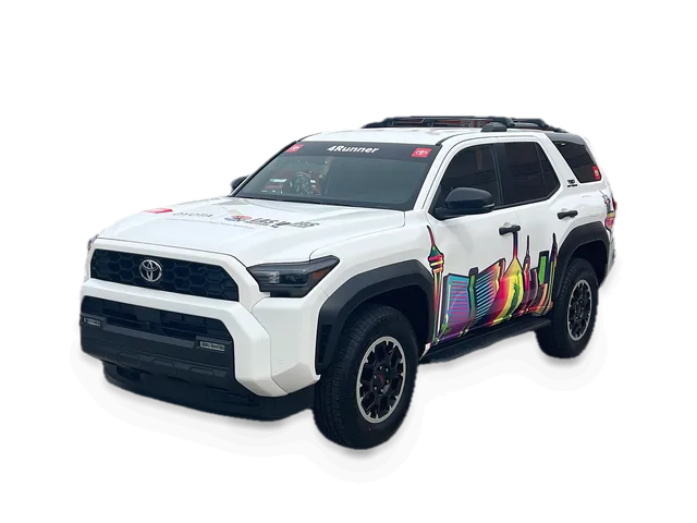 White sixth-generation Toyota 4Runner with a skyline door graphic